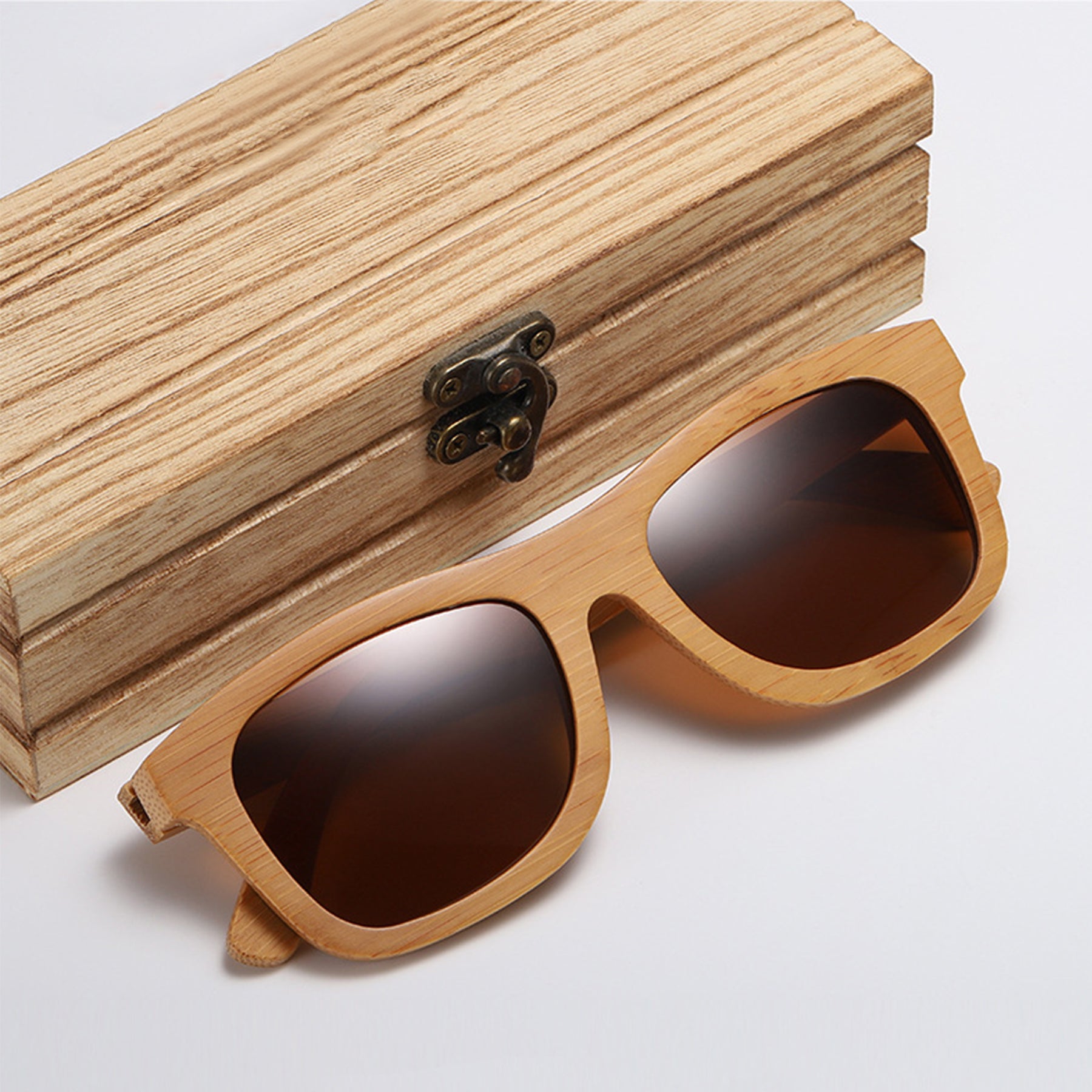 Brown polarized lens bamboo sunglasses near a wooden box