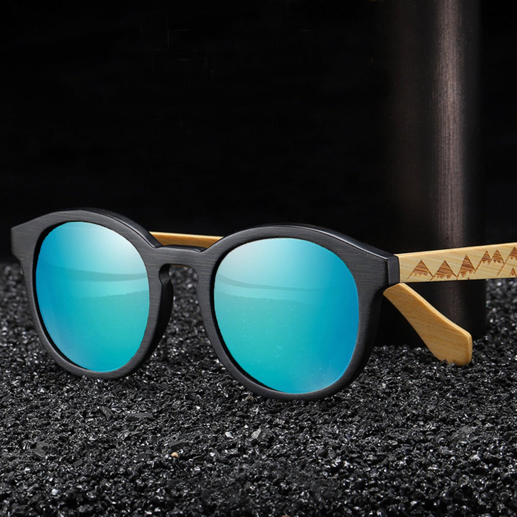 Blue lens engraved bamboo arms sunglasses on black ground