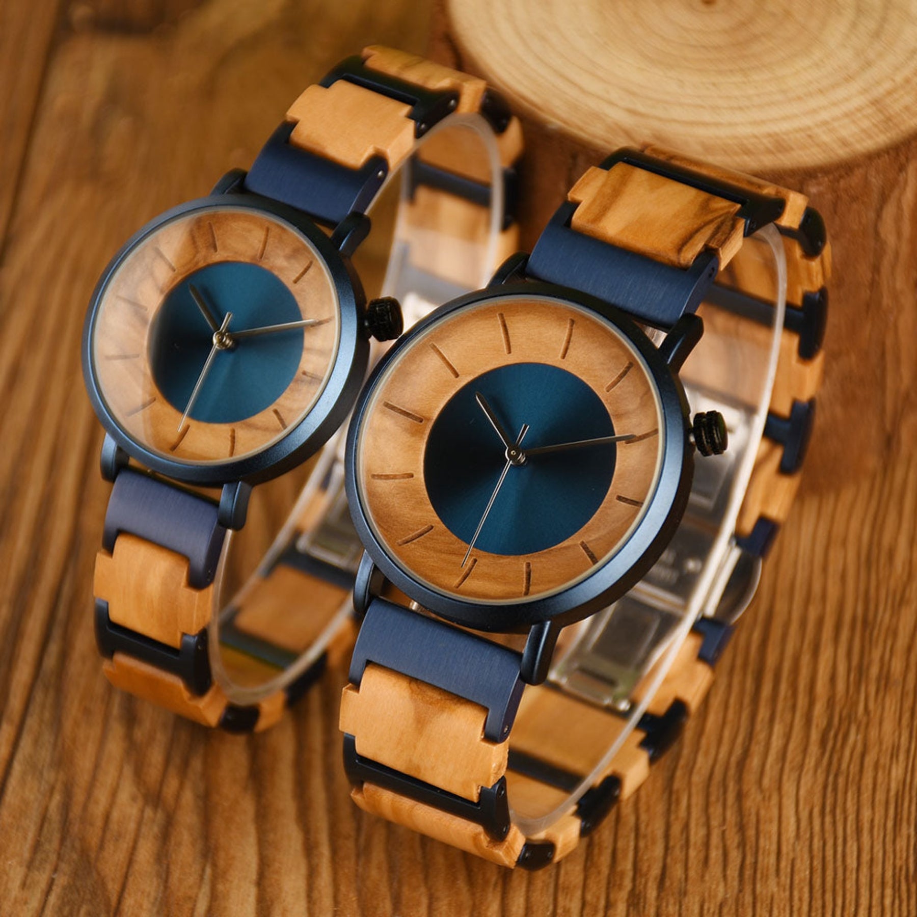 Blue steel and olive minimalist couple watches standing on the wooden table
