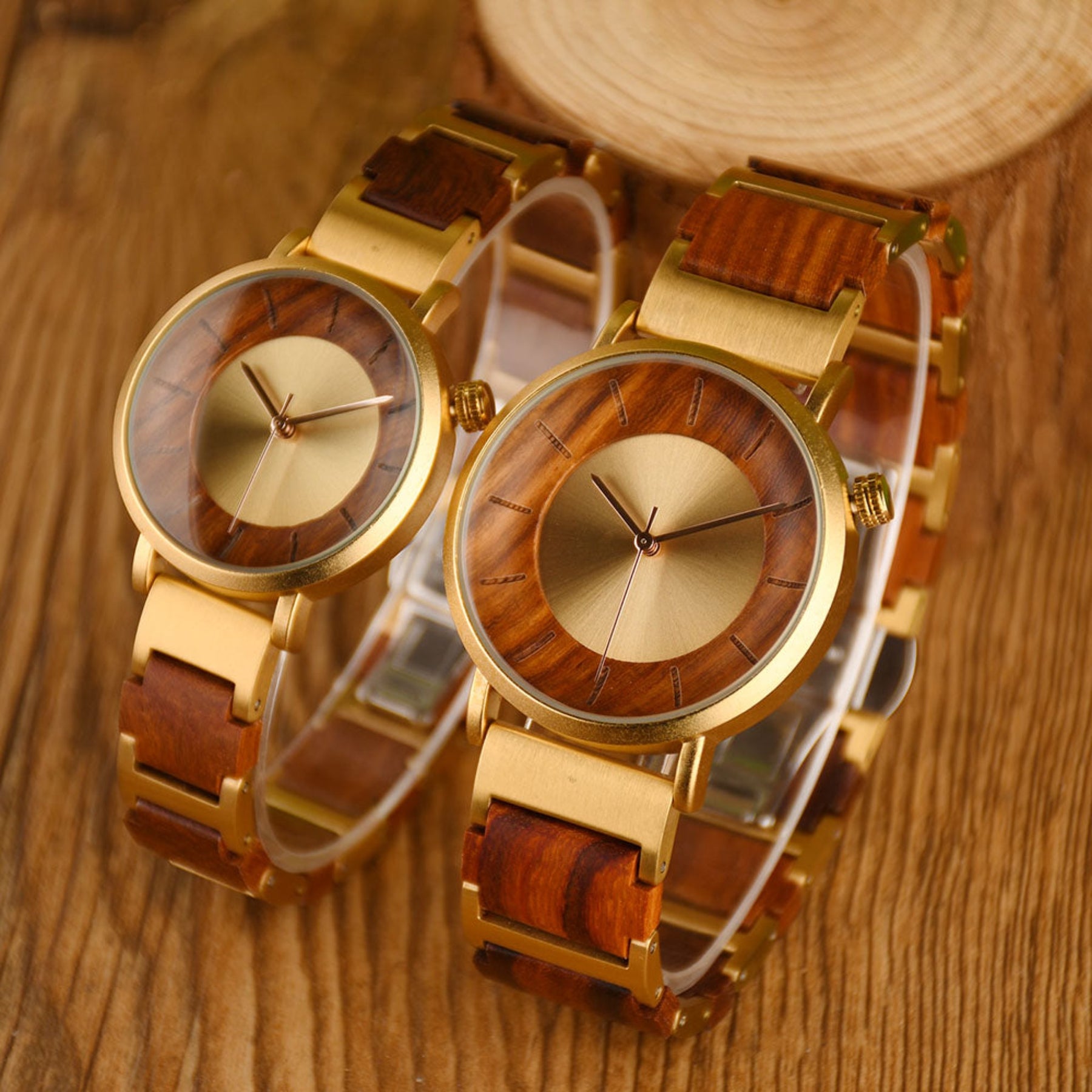 Golden steel and red sandalwood couple watches standing on the wooden table
