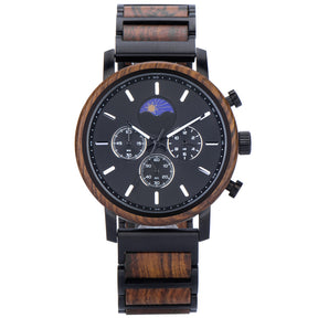 A stylish chronograph watch with a wooden bezel, black metal and wood combined band, featuring a moon phase complication on a black dial, isolated on a white background.