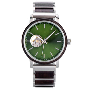 A sophisticated skeleton automatic watch featuring a green dial, wooden bezel, and silver metal with wood combined band, isolated against a white background.