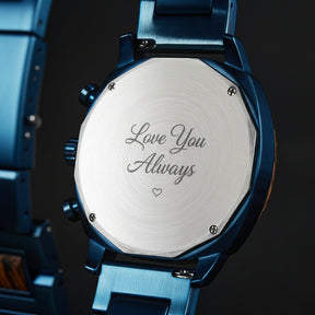 A detailed view of the back case of a men's wooden chronograph watch with a blue dial, showcasing its metallic finish and structural design elements.