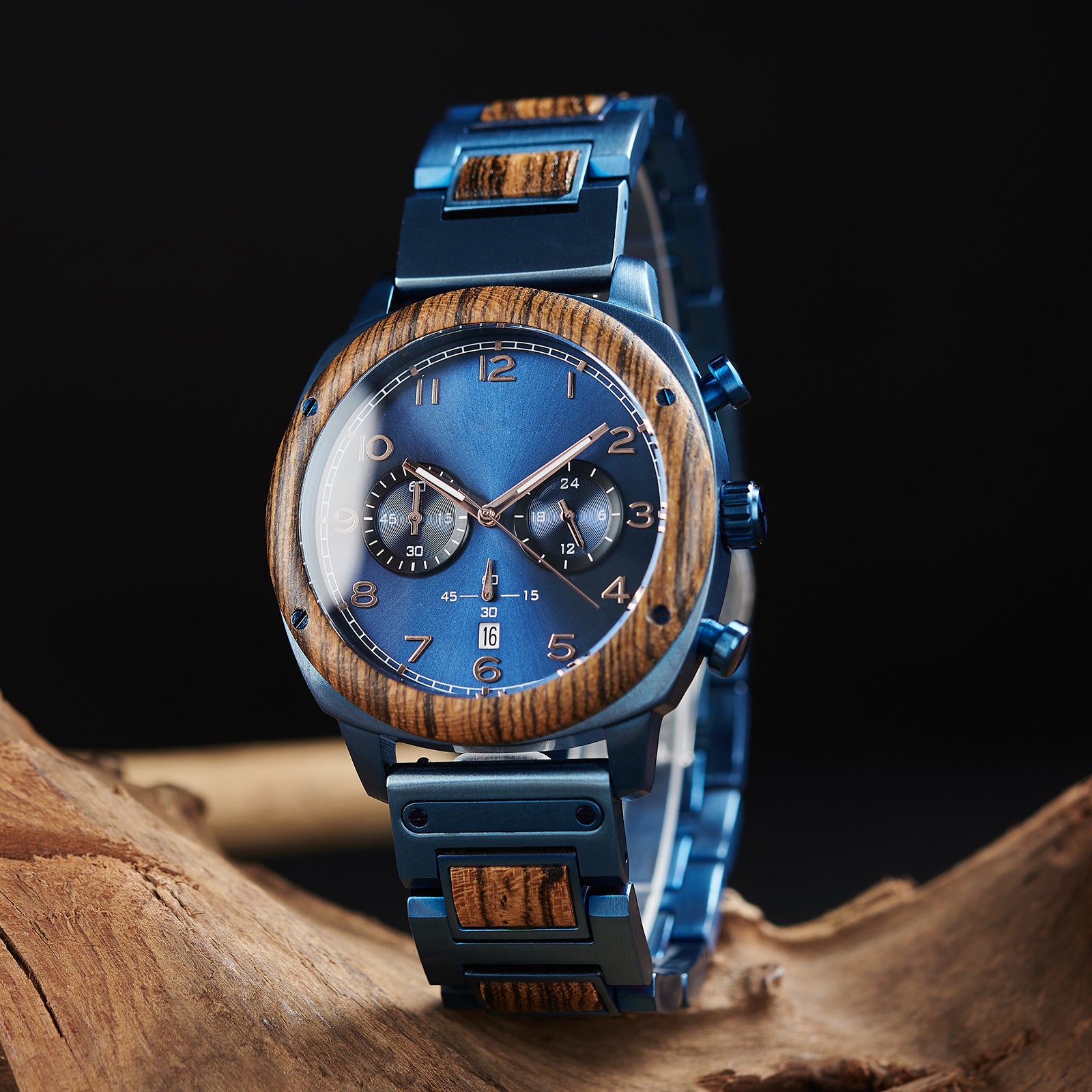 A stylish men's wooden chronograph watch with a blue dial and wooden bezel, showcased on natural wood to highlight its sophisticated and rugged design.