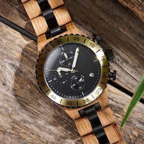 A detailed view of a men's wooden chronograph watch with gold and black accents, displayed on a wooden surface to emphasize its craftsmanship and rugged design.