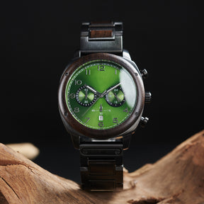 A stylish men's wooden chronograph watch with a green dial and dark accents, showcased on natural wood to highlight its sophisticated and rugged design.