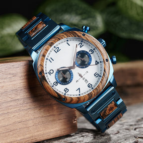 A stylish men's wooden chronograph watch with a white dial and blue accents, showcased on natural wood to highlight its sophisticated and rugged design.