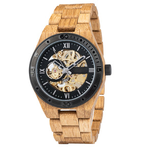 A men's automatic mechanical watch made of oak wood and black stainless steel, featuring a skeleton dial that displays intricate golden mechanical movements, marked with Roman numerals and a black bezel, presented against a plain white background.
