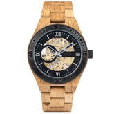 A men's automatic mechanical watch crafted from oak wood and black stainless steel, featuring a skeleton dial that reveals intricate golden mechanical movements, marked with Roman numerals and a black bezel, presented against a plain white background.