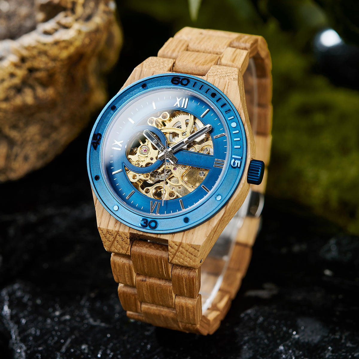 A men's automatic mechanical watch featuring an oak wood strap and blue stainless steel elements, showcasing a skeleton dial with visible golden gears, positioned against a natural-inspired background.