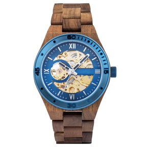 A men's automatic mechanical watch made of walnut wood and blue stainless steel, featuring a skeleton dial that reveals intricate movement, displayed against a white background.
