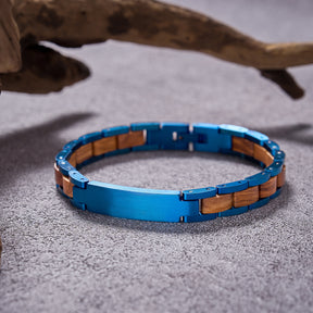 Men's bracelet crafted from blue stainless steel and olive wood, a stylish and unique accessory for men, featuring a blend of metal and wood for a rugged yet refined look.