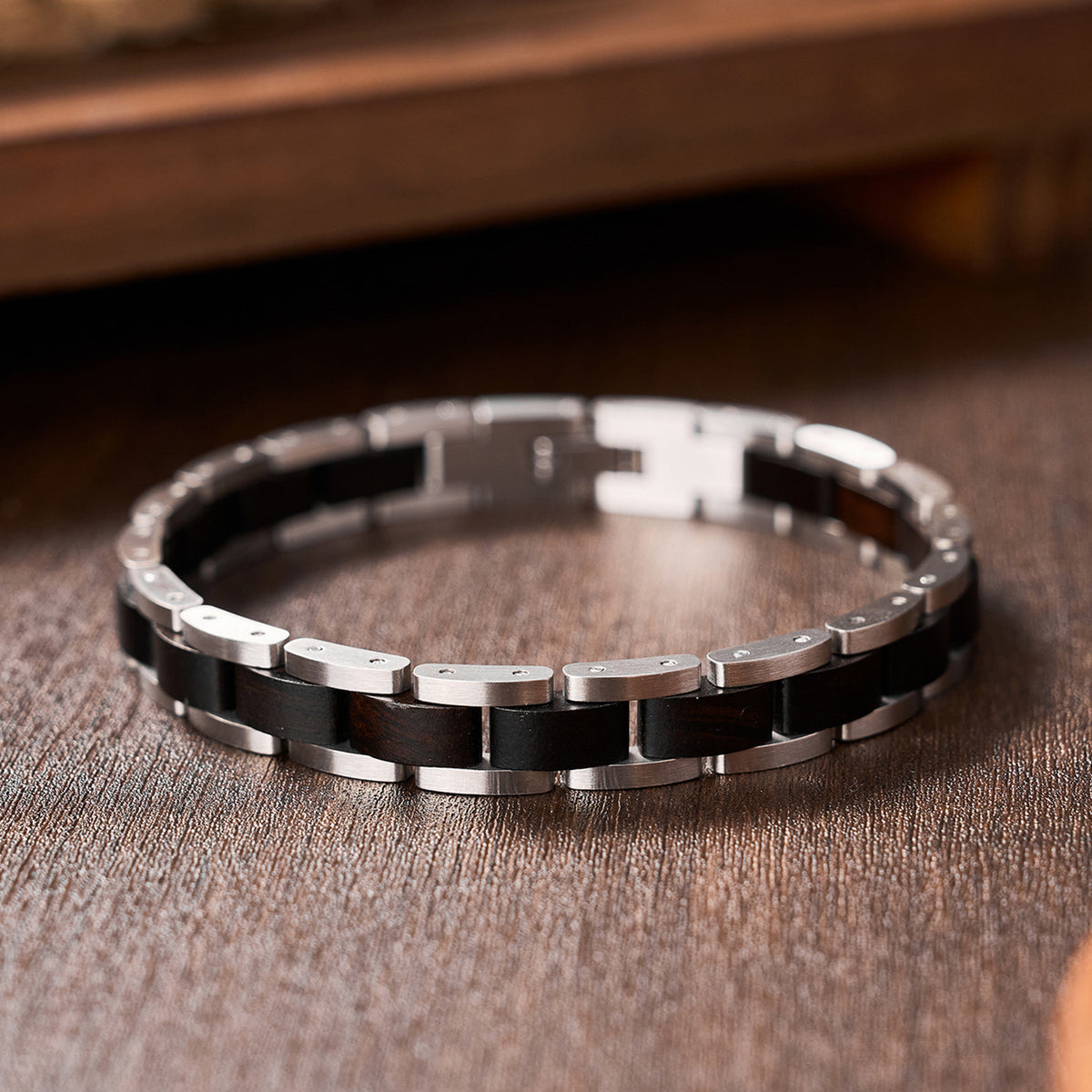 Men's bracelet crafted from ebony wood and silver stainless steel, a sleek and unique accessory for fashionable men.