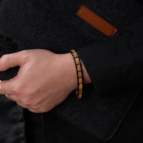 Men's bracelet with oak wood and black stainless steel, showcased on a man's wrist, a trendy and unique accessory for modern men.