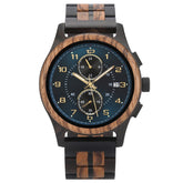 A men's chronograph watch with a combination of dark wood and black metal band, featuring a dark teal dial with gold-tone numerals, hands, and sub-dials, along with a date display, isolated on a white background.
