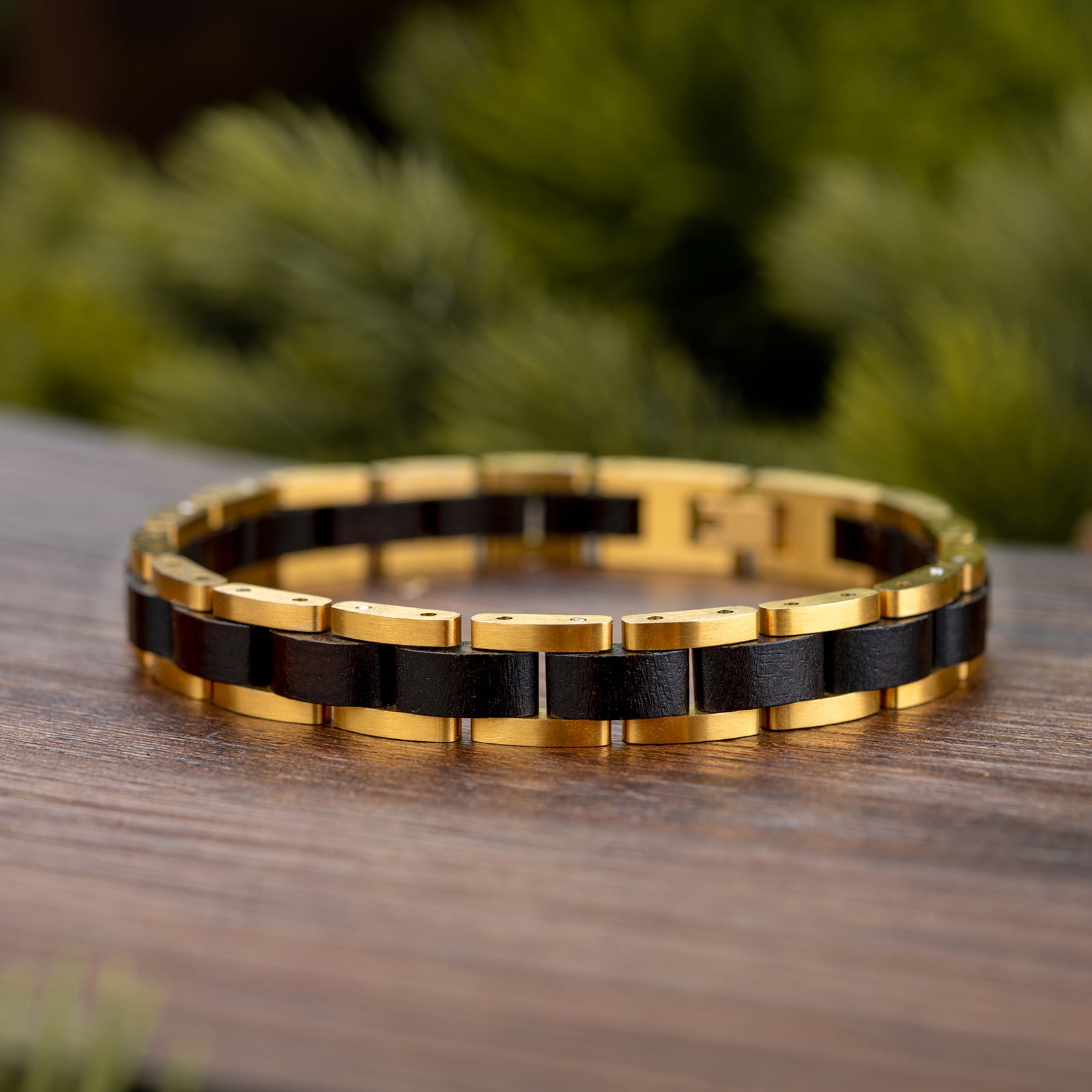 Men's wooden bracelet with gold-tone stainless steel and black wood links, stylish accessory for men, perfect for casual or formal wear.