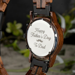 A detailed view of the back of a men's wooden chronograph watch, showcasing its brown wood construction, black metal accents, and metallic case back, highlighting the craftsmanship and design details.
