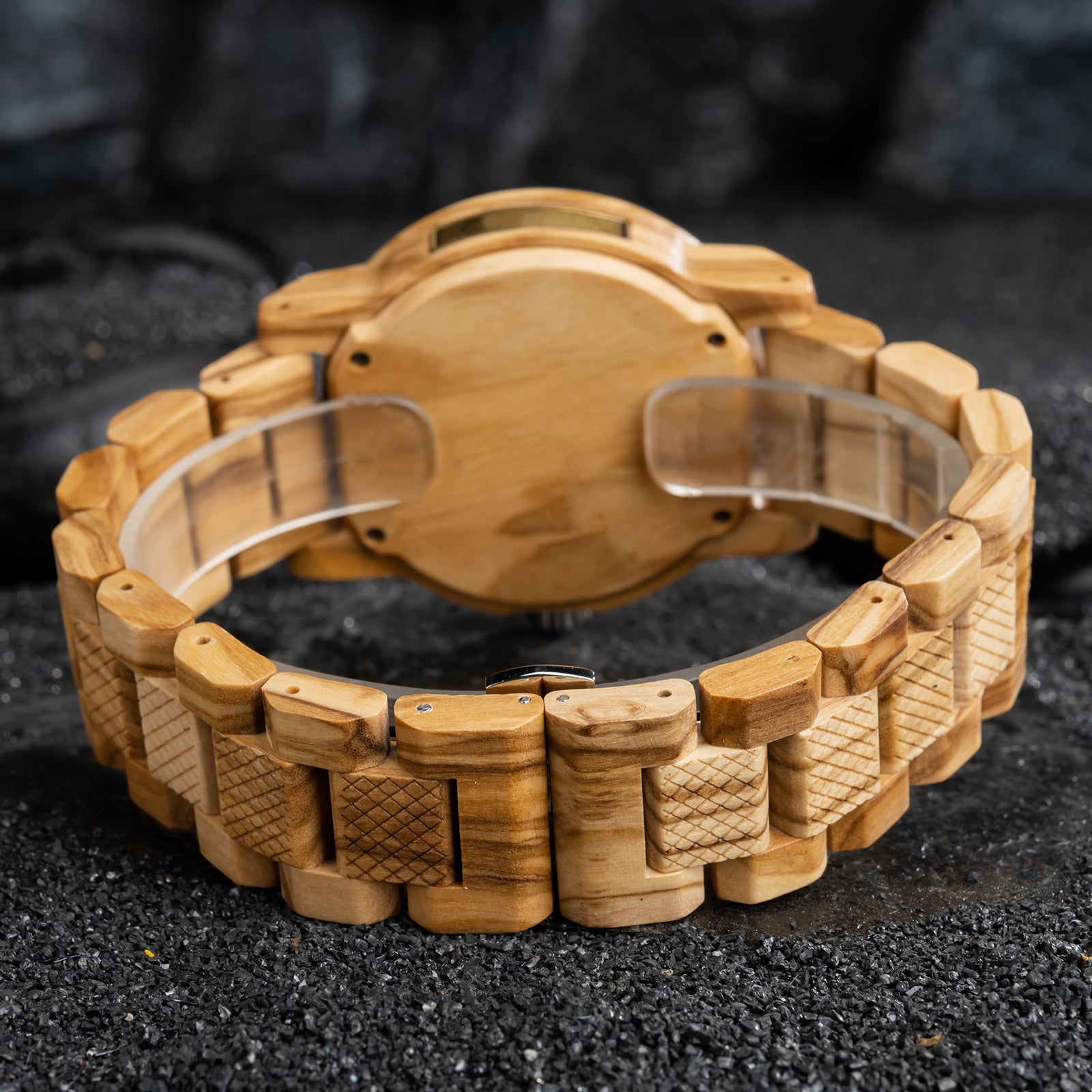 A detailed view of the back and band of a men's wooden watch, showcasing its light brown wood construction and textured details, highlighting the craftsmanship and natural aesthetic.
