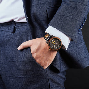 A sophisticated men's wooden watch featuring a dark gray dial, showcased on a wrist wearing a navy suit, emphasizing its elegant and professional aesthetic.