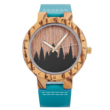 A unique wooden watch with a runic symbol bezel, forest silhouette dial, and turquoise leather band, featuring a natural wood texture and gold-tone hands against a white background.