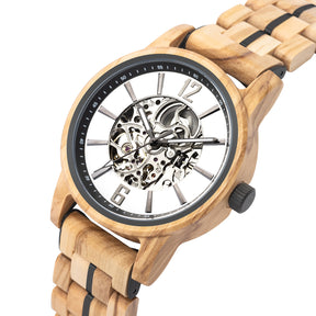 Angled view of a wooden wristwatch with a white dial, full skeleton movement, and black-accented wooden band, isolated on a white background.
