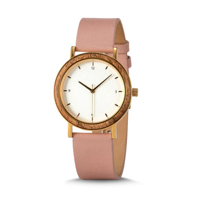 A minimalist women's watch with a wooden-accented bezel, white dial, gold-tone details, and a pink leather band, presented against a white background.