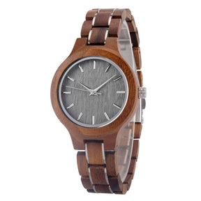 A refined women's walnut watch with silver-tone accents, shown in side view against a white background to highlight its craftsmanship and elegant design.