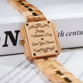 A detailed view of the back case of a women's wooden watch with a green dial and gold accents, showcasing its natural wooden construction and structural design elements.