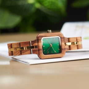 A stylish women's wooden watch with a green dial and gold accents, showcasing its natural wooden design and elegant aesthetic.