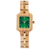A sophisticated women's wooden watch with a green dial and gold accents, presented against a white background to highlight its refined and elegant design.