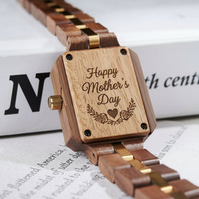A detailed view of the back case of a women's wooden watch with a red dial and gold accents, showcasing its natural wooden construction and structural design elements.