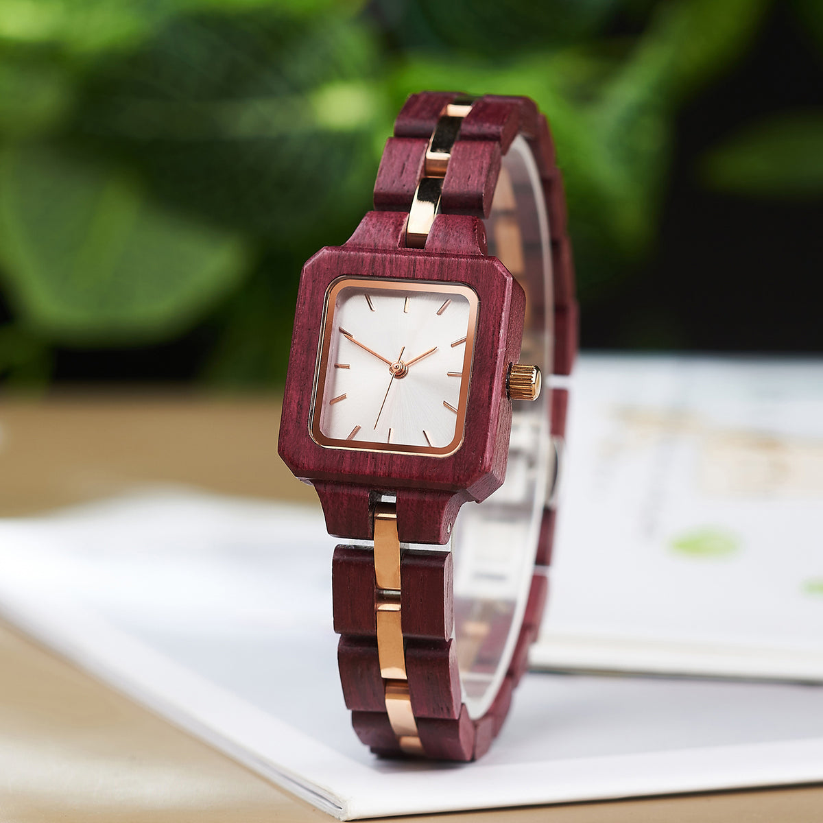A stylish women's wooden watch with a white dial and rose gold accents, showcasing its natural wooden design and elegant aesthetic.