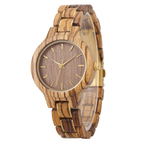 A refined women's zebrawood watch with gold-tone accents, shown in side view against a white background to highlight its craftsmanship and elegant design.
