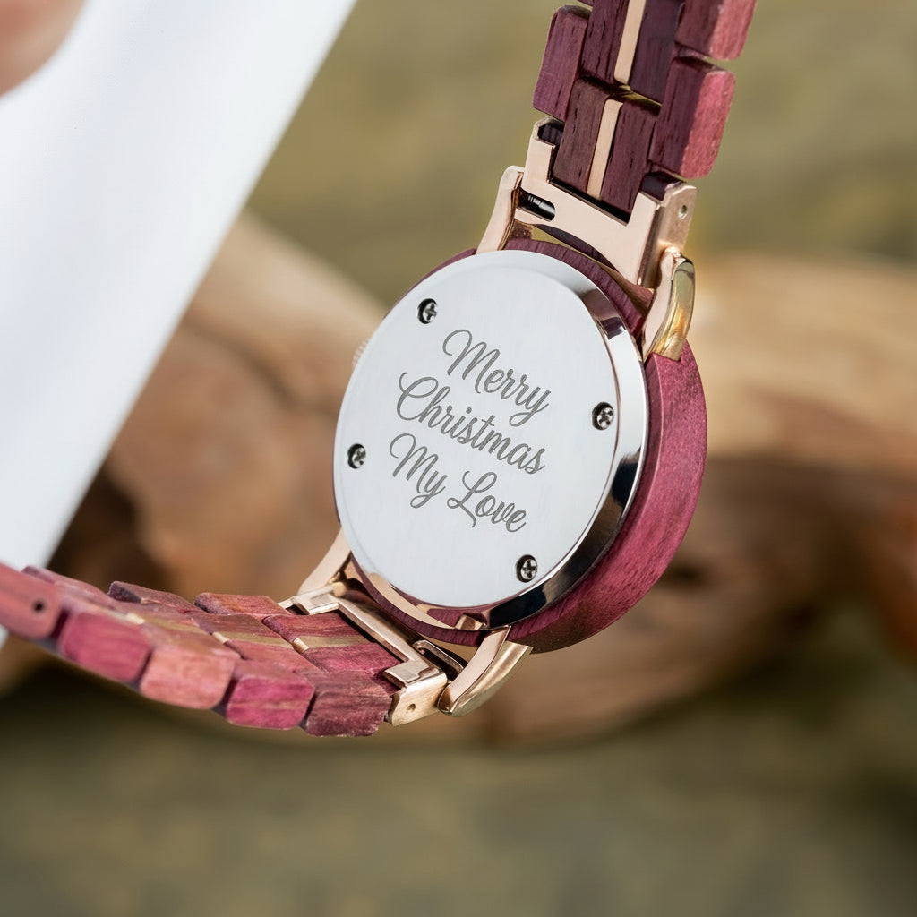 A detailed view of the back of a women's wooden watch, showcasing its red-purple wood band, rose gold accents, and metallic case back, highlighting the craftsmanship and design details.