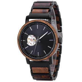 A stylish automatic watch with a wooden bezel, black metal and wood combined band, featuring a skeleton movement window on a black dial, presented at an angle against a white background.
