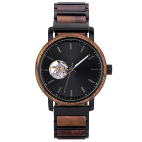 A stylish automatic watch with a wooden bezel, black metal and wood combined band, featuring a skeleton movement window on a black dial, isolated against a white background.