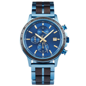 A chronograph watch with a combination of blue metal and dark wood bracelet, featuring a blue dial with multiple sub-dials, 24-hour markers on the bezel, and a date window, presented against a white background.