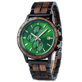 A chronograph watch with a combination of black metal and light wood bracelet, featuring a green dial with multiple sub-dials, 24-hour markers on the bezel, and a date window, shown from a side angle against a white background.