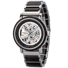 A skeleton mechanical watch with a mixed wooden and metal bracelet, displayed in a side angle, featuring an open-work dial with intricate movement, dark wooden bezel, and stainless steel accents.