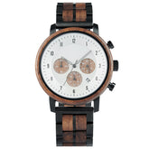 A chronograph watch with a combination of wooden and black metal bracelet, featuring a white dial with brown chronograph sub-dials, numerical hour markers, and a date window, presented against a white background.