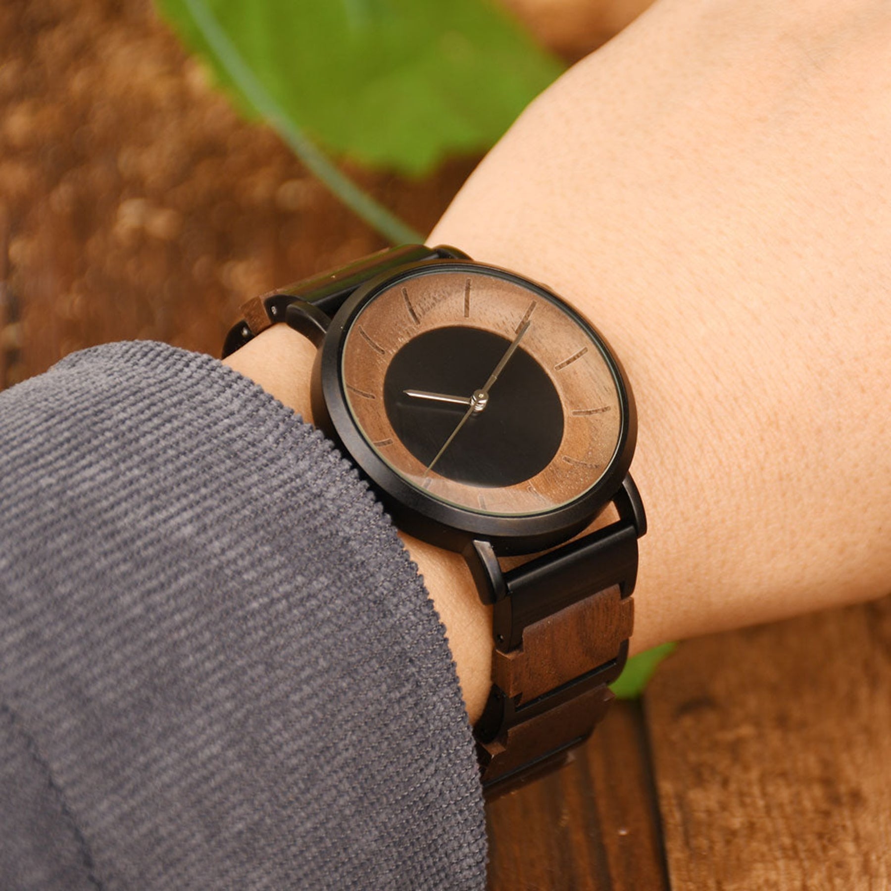 A man wearing a black steel and walnut simple quartz watch