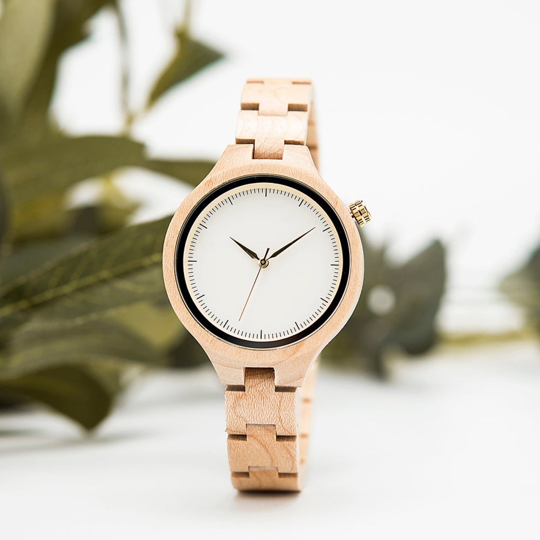 The white face maple women wooden watch standing on table