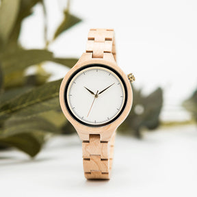 The white face maple women wooden watch standing on table